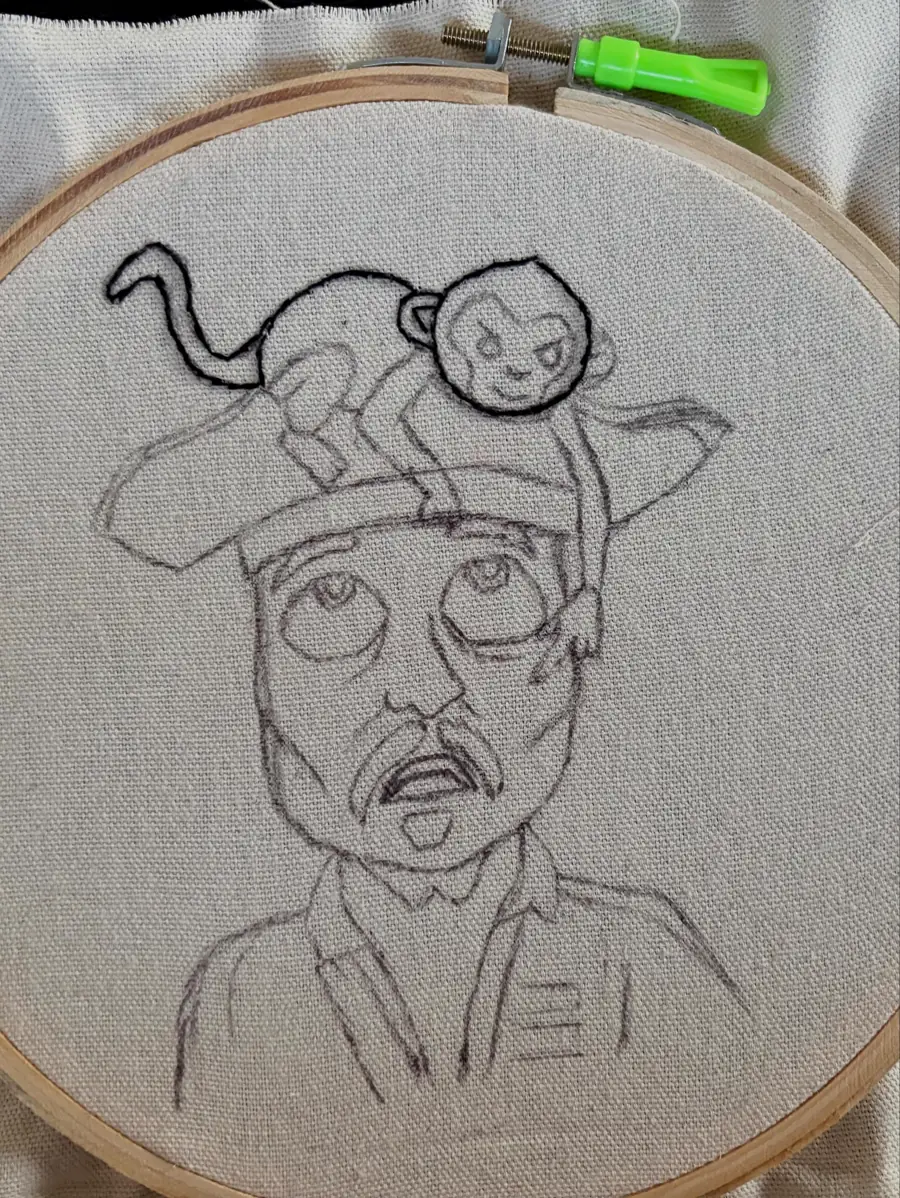 Pencil sketch on fabric in a hoop, the first step of a custom embroidered portrait from photo